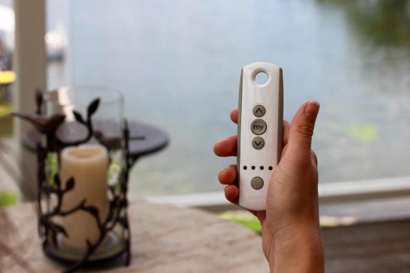Pennsylvania resident holding the remote their motorized retractable awning